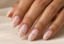 Unhas de renda: a nail art delicada que transforma desenhos em bordados Unhas de renda branca sobre base nude com desenhos delicados que lembram bordados.